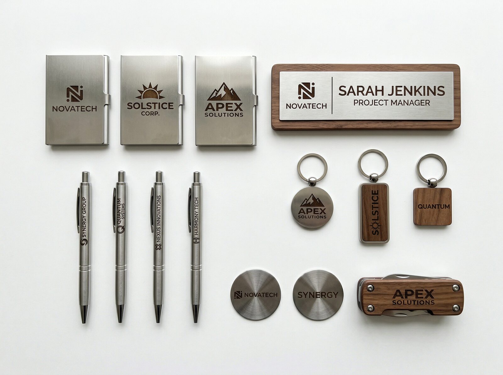 Variety of custom laser-engraved business items including branded pens, keychains, signs, and promotional products
